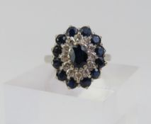 A white gold sapphire and diamond tiered cluster r