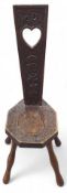 A decorative early 20th century oak stool