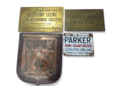 Three metal signs and a copper plaque. The plaque