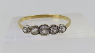 An early to mid-20th century five stone paste ring