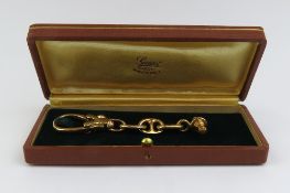 Gucci - a yellow gold keyring, with three mariner