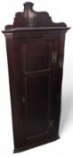 A mahogany corner cupboard