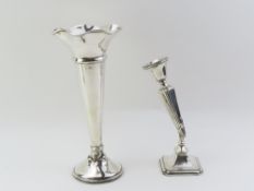 A silver trumpet vase and a candlestick holder