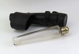 A glass hunting flask with metal top, stored in a