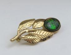 A 9ct gold solid black opal brooch, the oval caboc