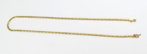 A gold necklace with intersecting triangular flat