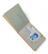 A small book of autographs, including Tommy Cooper