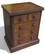 An oak apprentice chest of two short and three lon