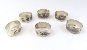 A collection of white metal napkin rings