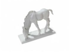 A Meissen blanc de chine figure of a horse grazing