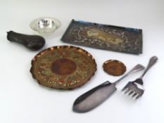 A round copper tray with embossed grape vines