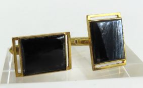 A pair of black onyx set cufflinks, the rectangular
