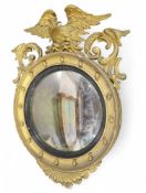A large porthole mirror with gilt frame. With flor