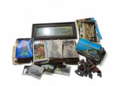 A large collection of postcards, along with a fram