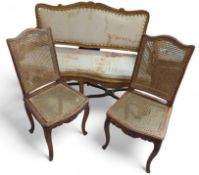 A pair of cane seated chairs and a cane seated sofa