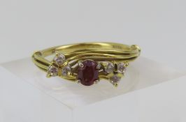 An 18ct gold garnet and diamond dress ring, the ov