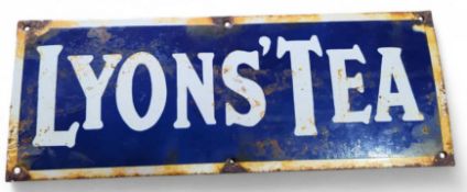 A rectangular enamel sign advertising 
