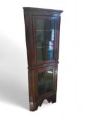 A two-part oak corner cupboard