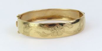 A gold hinged bangle