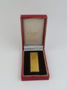Cartier - a vintage gold plated lighter, the recta