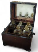 A mahogany case with lined velvet interior