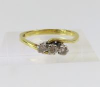 An 18ct gold diamond three stone twist ring, the u