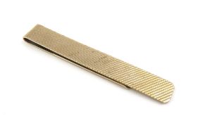 An unmarked yellow metal money clip, with engraved