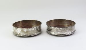 A pair of silver wine-bottle coasters