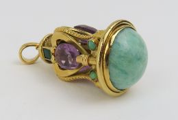 An unusual pendant set with amethyst, emerald, tur