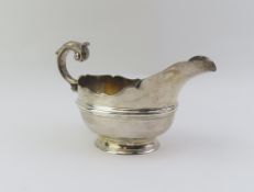 A large silver sauce boat