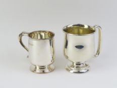 A pair of silver christening mugs