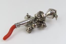 A Georgian silver and red coral rattle