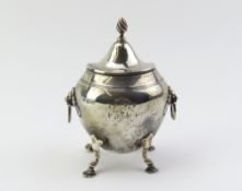 A decorative silver lidded tea caddy