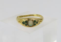 A late 19th century 18ct gold white opal and green