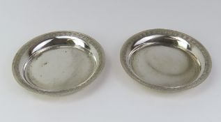 A pair of small white-metal dishes