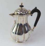 A Victorian silver lidded chocolate pot