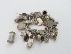 A silver curb link bracelet with a heart padlock a