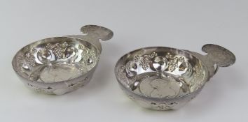 A pair of silver wine-tasting cups