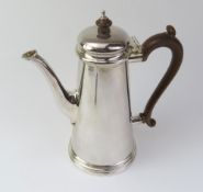 A silver coffee pot with wooden