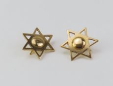 A pair of unmarked six pointed star shaped earring