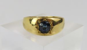 An unmarked sapphire set gypsy ring with a partial hallmark,