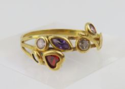 An 18ct gold gem set dress ring, the floriate desi