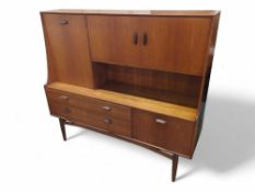 A mid-20th century sideboard, with top cupboards envelo