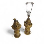 A pair of ornate gilded metal lamps, the bodies of