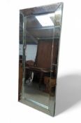 A large, modern, rectangular mirror