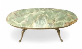 A decorative brass table with green onyx top