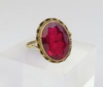 A 9ct gold synthetic ruby ring, with split shoulde