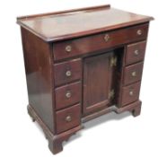 A stained mahogany knee-hole desk, with long top d