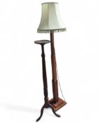 A mahogany plant stand with small circular top