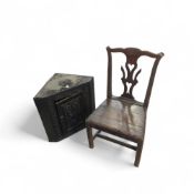 A dark stained oak corner cupboard with floral car